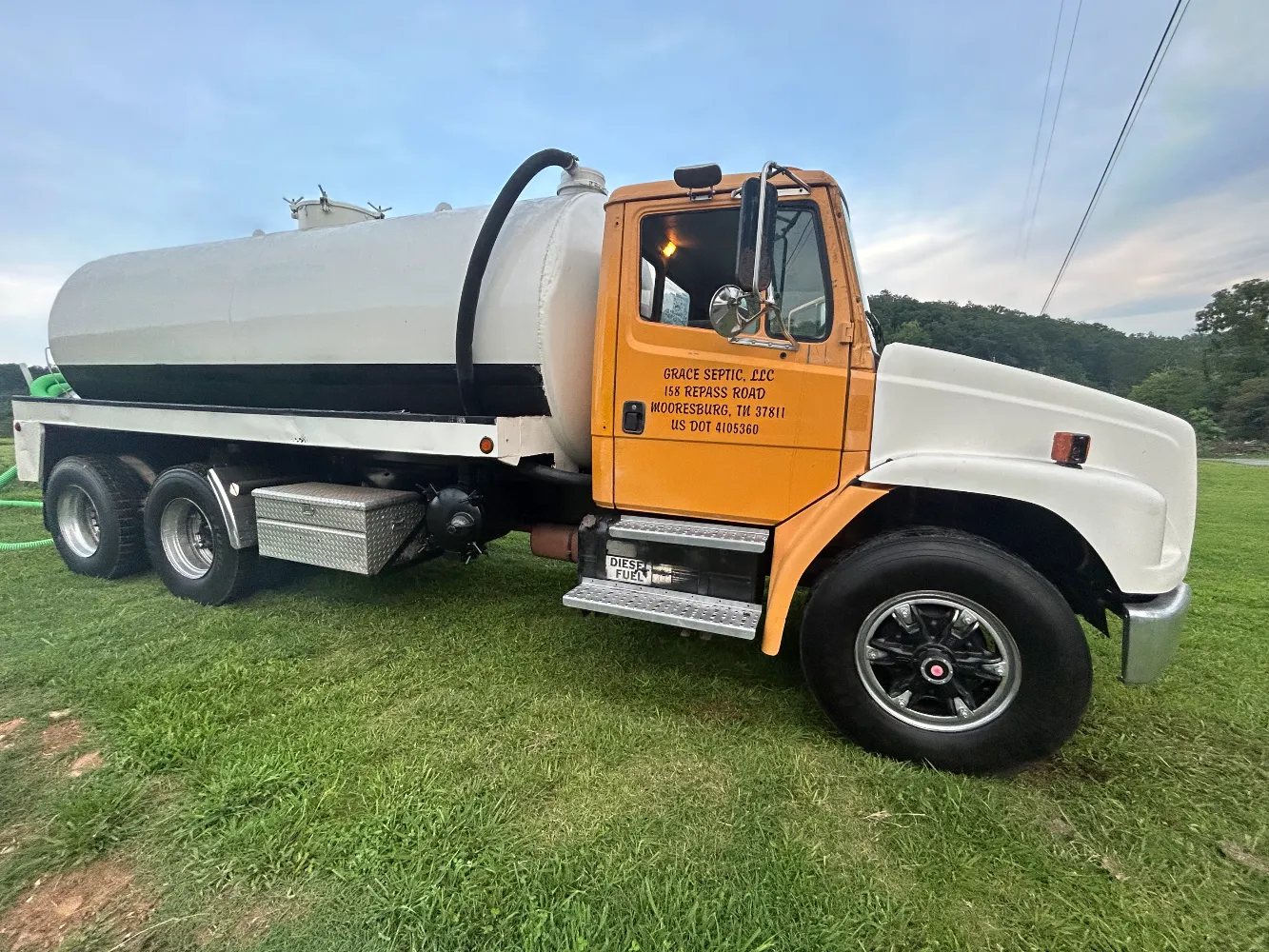 The Grace Septic pump truck: a white vacuum tank on a yellow-cabbed truck, lettered Grace Septic LLC, Mooresburg, TN.